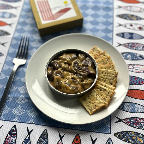 An opened tin of ABC+ Small Squids (Lulas) in Curry Sauce