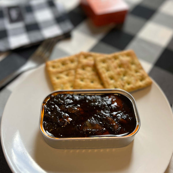 Ati Manel Squids in Ink served in an opened tin with some crackers