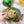 Load image into Gallery viewer, A person's hand using a fork to pick out a fish from a tin of Lata Small Sardine in Oil with Jalapeños
