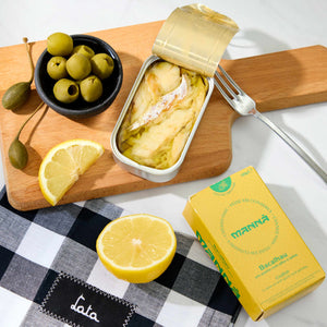 An opened tin of Manná Codfish in Olive Oil with Garlic and Parsley