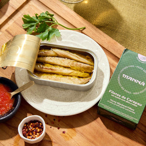 An opened tin of Manná Horse Mackerel Fillets in Olive Oil with Garlic and Parsley