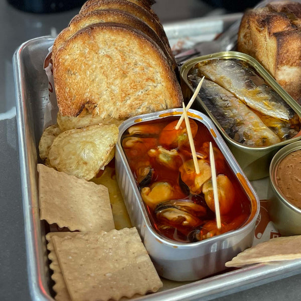 Samare Spiced Mussels in Pickled Sauce served with toasted bread, crackers and sardines