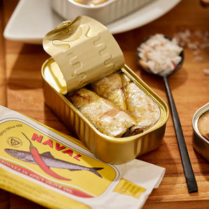 An opened tin of Naval Sardines in Spicy Olive Oil