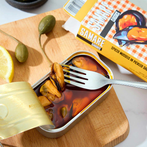 An opened tin of Samare Spiced Mussels in Pickled Sauce