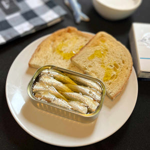 La Brújula Small Sardines in Olive Oil served in an opened tin