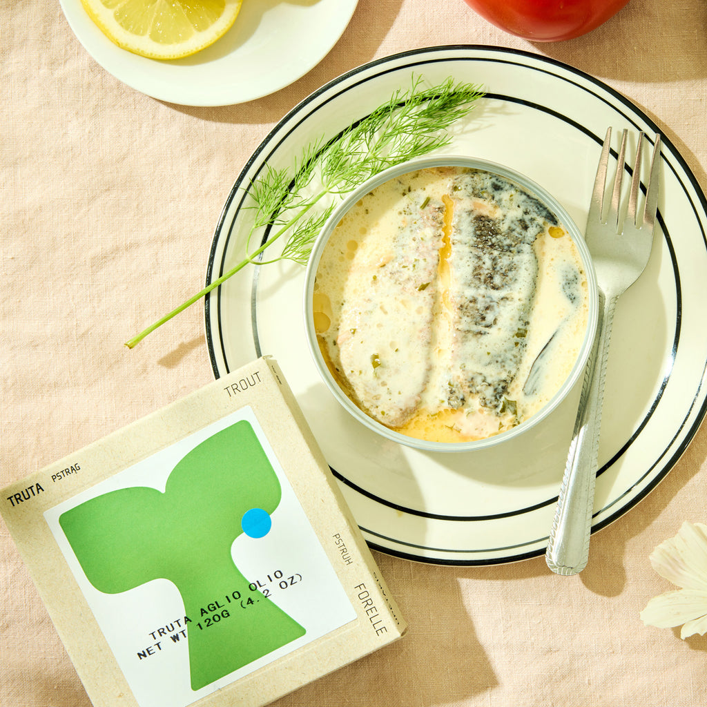 An open tin of ABC+ Trout Fillets in Aglio e Olio sauce visible from above 