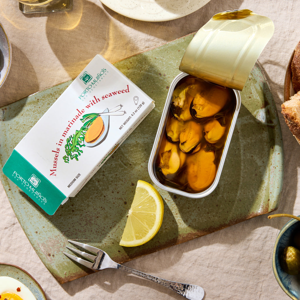 An opened tin of Porto-Muinos Mussels in Marinade with Seaweed