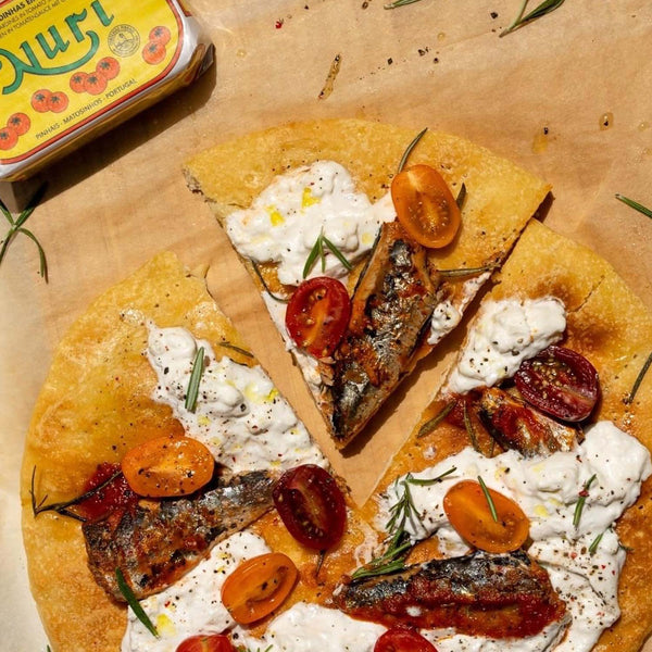 Nuri Sardines in Tomato Sauce served on pita bread with tomatoes