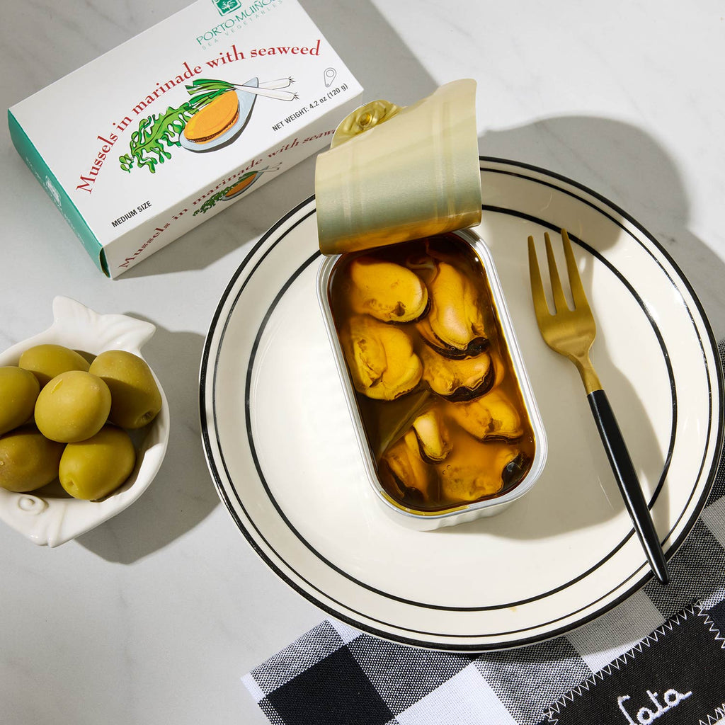 An opened tin of Porto-Muiños Mussels in Marinade with Seaweed