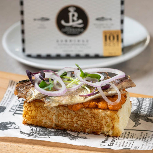 Real Conservera Española Sardines in Olive Oil served on toasted bread with finely cut onions