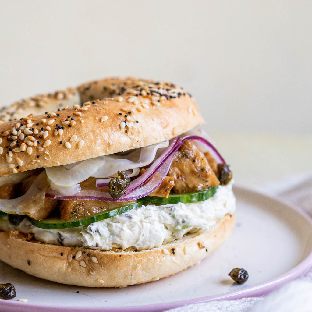 A cream cheese bagel with cucumber and the Seed to Surf Celery root whitefish