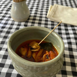 Portomuiños Mussels in Brava Sauce and Sugar Kombu served in a bowl