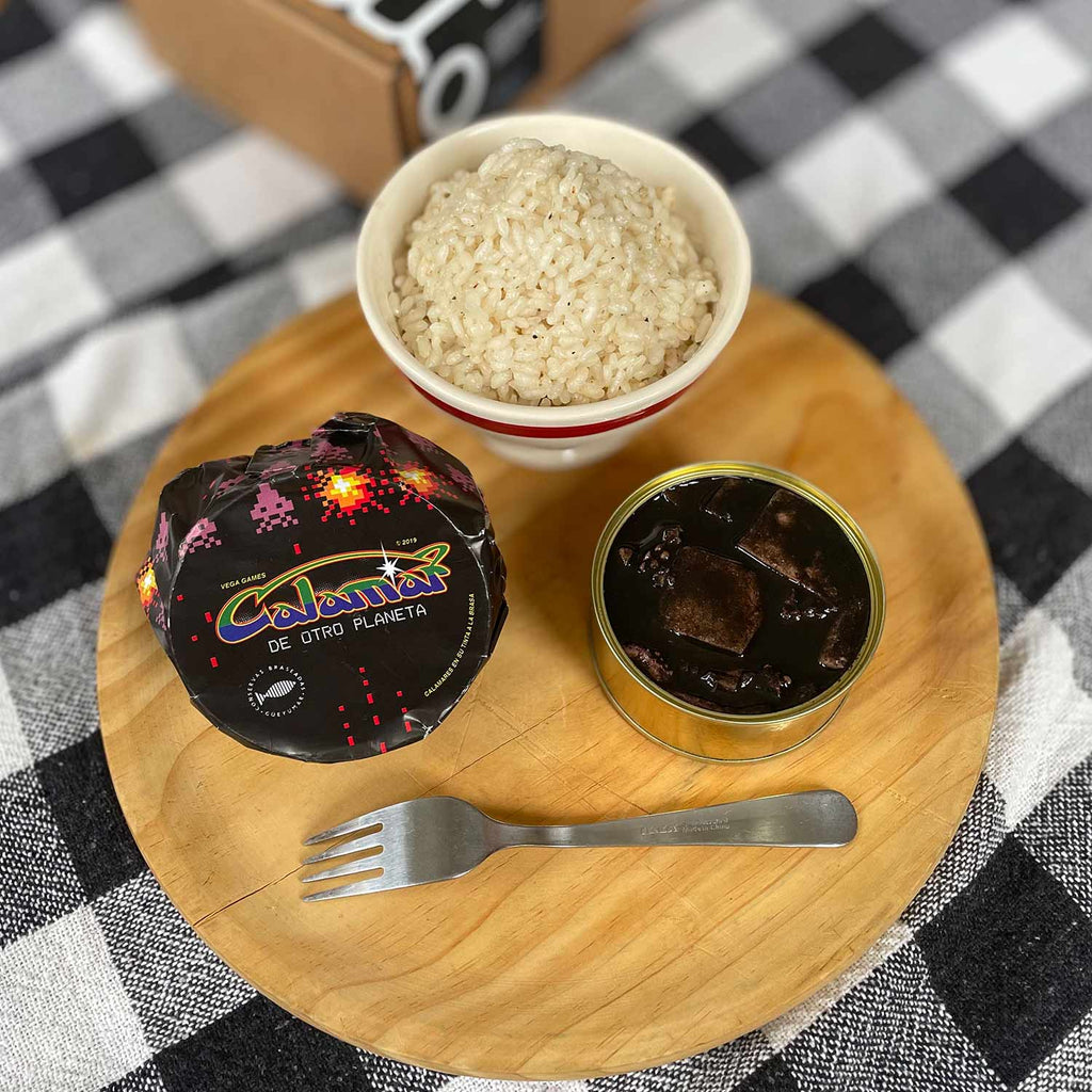 Güeyu Mar Squid In Ink Sauce served in an opened tin with rice