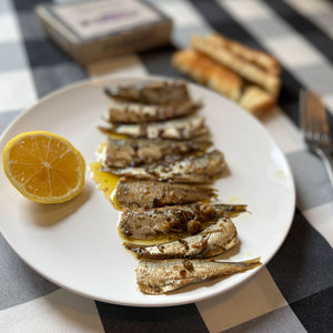 Fangst Brisling No. 1 Baltic Sea Sprat Smoked with Heather & Chamomile - beautifully served with lemon